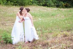 two women in white dresses standing next to each other