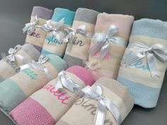 six personalized towels wrapped in different colors