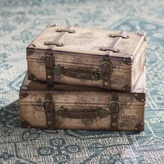 two suitcases sitting on top of a rug