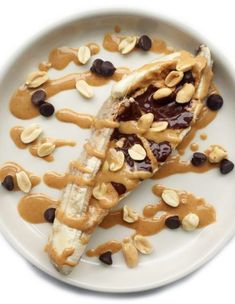 a white plate topped with dessert and nuts