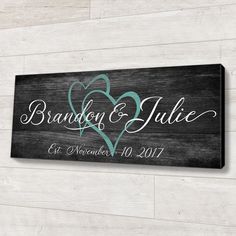 a wooden sign that says brandon and julia on it, with two hearts in the center