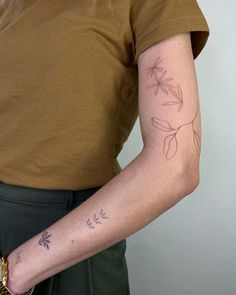 a woman with a flower tattoo on her arm