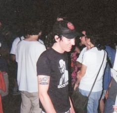 a group of young men standing next to each other in front of a crowd at night