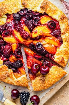 a pie with fresh fruit on top is cut into slices