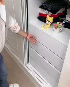 a young child standing in front of a closet