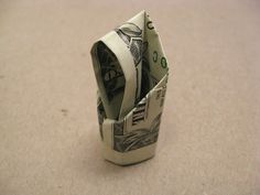 an origami dollar bill folded up into a small pocket on the floor,