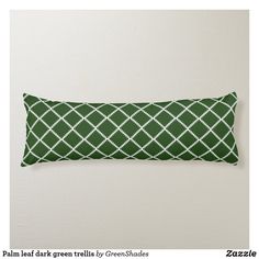 a green and white decorative pillow on a wall with the text palm leaf green trelliss by greenshades