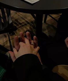 a person is holding their hand on the table