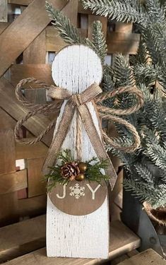 a wooden block with a christmas decoration hanging from it