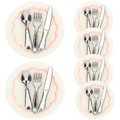 six forks and spoons are arranged on a plate