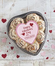 a heart shaped box filled with cinnamon rolls