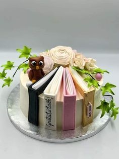 a cake decorated with books and an owl