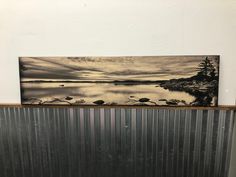 a metal radiator in front of a painting on the wall