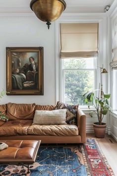 a living room filled with furniture and a painting hanging on the wall over a window