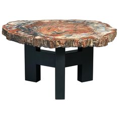 a table made out of wood and metal with an artistic design on the top, it is