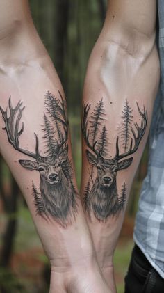 two people holding hands with tattoos on their arms that have deer and pine trees on them