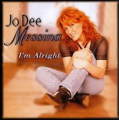 a woman sitting on the floor with her hands clasped in front of her chest and text jo dee messino i'm alright