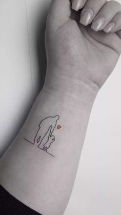 a woman's arm with a small tattoo on the left side of her wrist