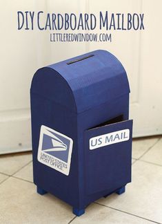 a blue mailbox sitting in front of a white door with the words diy cardboard mailbox