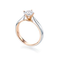 a gold and silver ring with a white diamond