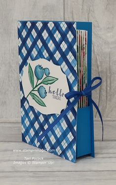 a blue and white checkered card with ribbon