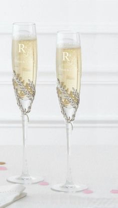 two champagne flutes are sitting next to each other