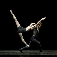 two dancers in black and white pose for the camera