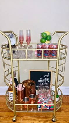 a gold bar cart filled with drinks and condiments