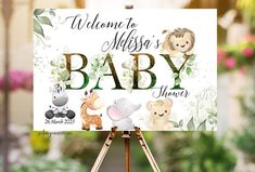 a baby shower sign on an easel in front of flowers and greenery with the words welcome to mississippi's baby shower