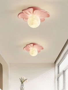 the ceiling lights in this room are shaped like flowers and have pink petals on them