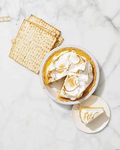 a white plate topped with a pie next to crackers