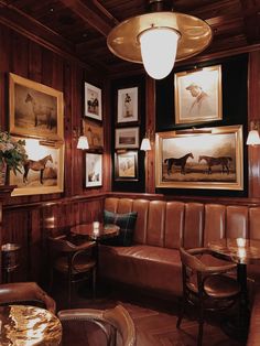 a living room filled with furniture and pictures on the wall