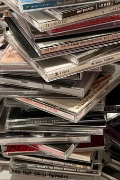 a pile of cds sitting on top of each other