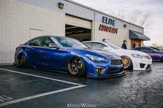 three different colored cars parked in front of a building