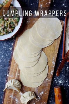 dumpling wrappers on a wooden cutting board next to bowls and utensils