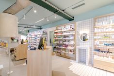 the inside of a pharmacy store with shelves and counter tops