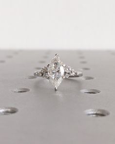 an engagement ring with three pear shaped diamonds