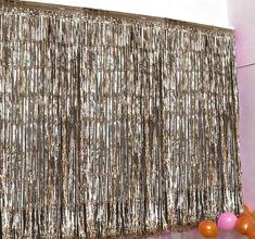 an image of a room that is decorated with gold sequins and pink balloons