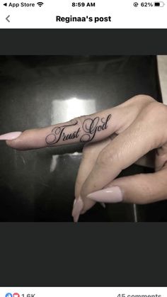 two hands with tattoos that say trust god