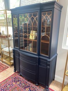 a blue china cabinet sitting on top of a rug