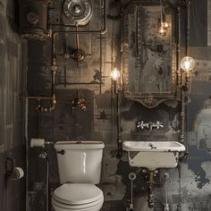 An industrial bathroom with a vintage-inspired, high-tank toilet and a wall-mounted sink with exposed plumbing4 Industrial Sink Bathroom, Industrial Bathroom Decor, Industrial Bathroom Design, Industrial Bathroom Lighting, Industrial Toilets, Industrial Loft Design, Industrial Design Style, Industrial Materials