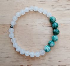 This attractive White Jade & Nephrite Jade healing bracelet has been created using 6mm and and 8mm natural gemstone beads. A Stainless Steel spacer bead provides the finishing touch.. White Jade is believed to have the positive power of light integral to the stone. It is a stone symbolic of light and hope and is associated with truth and compassion. Green Nephrite Jade is associated with the Heart Chakra and love.  It is a symbol of serenity. This bracelet stretches to fit, but please measure wrist accurately and specify wrist size in the options provided. Disclaimer: It should be noted that the above information regarding the healing properties of gemstones is not medical advice.  This is for information only and should not be seen as a substitute for consulting your doctor/health care pr White Jade Bracelets For Meditation, White Jade Crystal Bracelet For Healing, White Jade Crystal Healing Bracelet, Hand-strung White Jade Beaded Bracelets, Adjustable White Jade Beaded Bracelets, White Jade Beaded Bracelets With 8mm Beads, White Jade Bracelet, Yoga Beads, Wrist Mala