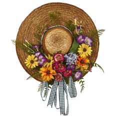 a straw hat with flowers on it hanging from the wall in front of a white background