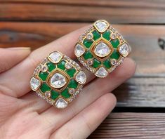 Polki Kundan Stud Earrings, inspired by Sabyasachi, feature a blend of emerald and ruby Kundan designs. Adorned with moissanite Polki diamonds and set in gold, these designer statement pieces showcase exquisite Indian craftsmanship. Perfect as a luxurious gift, they add timeless elegance to any jewelry collection. *𝐏𝐑𝐎𝐃𝐔𝐂𝐓 𝐃𝐄𝐓𝐀𝐈𝐋* * Material: Brass * Plating: Gold Plated * Stone: Semi Precious Kundan & Polki *𝐃𝐈𝐌𝐄𝐍𝐒𝐈𝐎𝐍𝐒* * Earrings- Weight: 10 gm Each, Length: 1.1 Inches, Designer Green Earrings For Gift, Green Earrings For Anniversary And Festivals, Green Temple Jewelry Earrings For Anniversary, Green Earrings For Formal Diwali Occasion, Green Formal Earrings For Diwali, Polki Studs, Sabyasachi Jewellery, Polki Earrings, Earrings Emerald