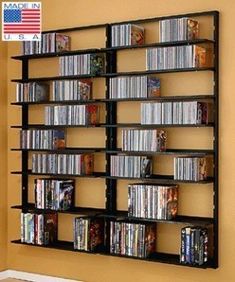 a wall mounted dvd rack with many movies on it