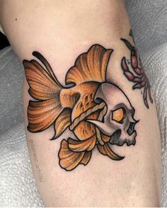 a goldfish with a skull on it's side is shown in this tattoo design