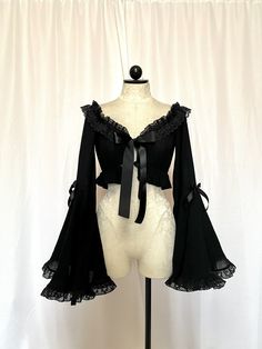 Stop the show and take a look at this beauty. Meet the Roselyn Top. She is a mystery and a blast. Roselyn is a crop top made with a gorgeous gauze stretch cotton, accompanied with a dramatic bell sleeved, Raschel ruffled lace trim, all tied together with a satin bow tie front.  iMPORTANT ♥️ Please contact us if you need or want an order by a certain time frame as our production and shipping times vary. We need to know in advance for orders with specific deadlines. Thank you! Bell Sleeve Bolero, Gothic Fitted Top With Sheer Sleeves, Fitted Gothic Top With Sheer Sleeves, Witchy Long Sleeve Party Tops, Witchy Long Sleeve Tops For Party, Elegant Cropped Tops With Sheer Sleeves, Gothic Cropped Top For Party, Evening Crop Top With Sheer Sleeves, Fall Crop Top With Sheer Sleeves