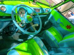 the interior of an old car with green and blue paint