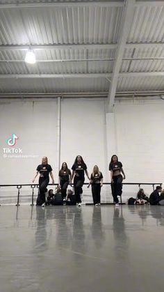 group of women in black t - shirts standing next to each other