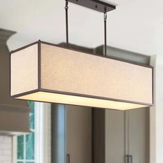 a light fixture hanging from the ceiling in a kitchen